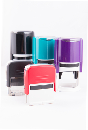 Automatic hand-stamps different colours on white backgroundの写真素材
