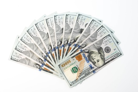 Fan of one hundred dollar bills isolated on white backgroundの写真素材