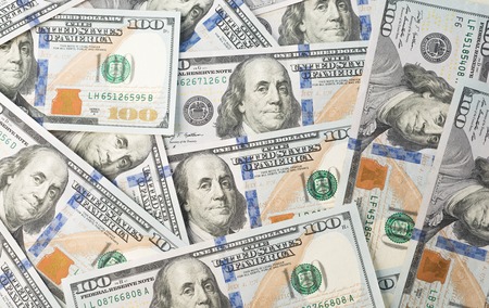 Heap of one hundred dollars as backgroundの写真素材