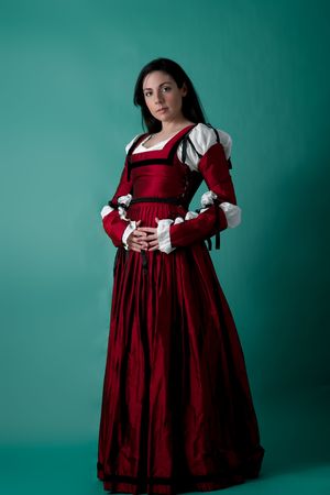 Beautiful brunette woman in red renaissance dress, on white backgroundの写真素材