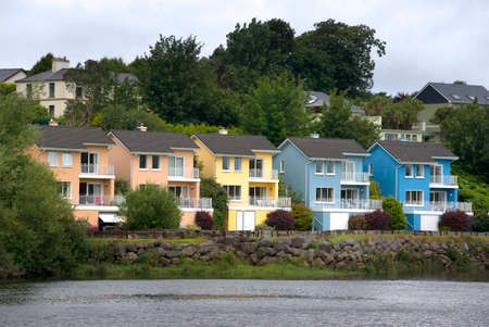 A row of colorful houses beside a riverの写真素材