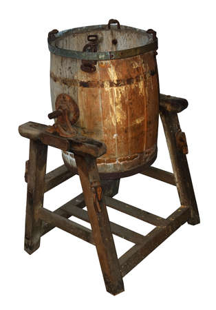 Old wooden butter churn on stand, battered and rustyの写真素材
