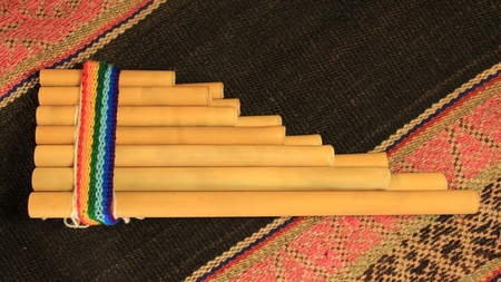 An Andean pan flute (known as a zampoÃ±a) on a traditional Andean textile.