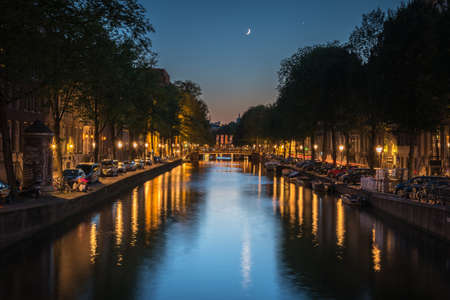 The moon reflected in the canal, Amsterdam, Netherlandsのeditorial素材