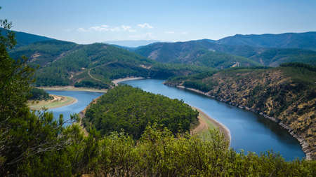 Meander of Melero surrounded by mountains on a day with blue sky, Riomalo de Abajo, Las Hurdes,...