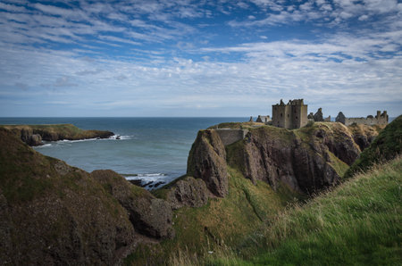 Dunnottar Castle on top of a cliff by the sea on a cloudy day, Stonehaven, Scotland, United Kingdomのeditorial素材