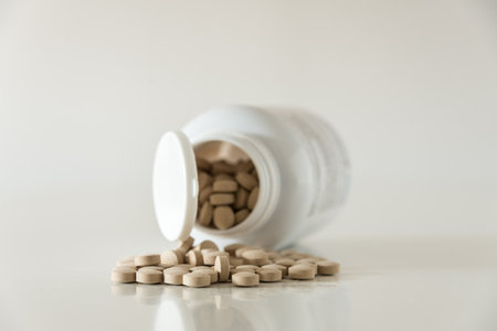 Pills in white bottle on white background close up with copy spaceの写真素材