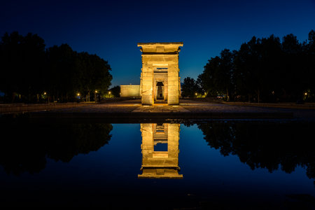The Egyptian Temple of Debod reflected in the waters of the lake at night, Madrid, Spaincted in the...