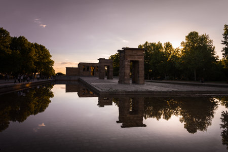 The Egyptian Temple of Debod reflected in the waters of the pond at sunset on a spring day, Madrid, Spainの写真素材
