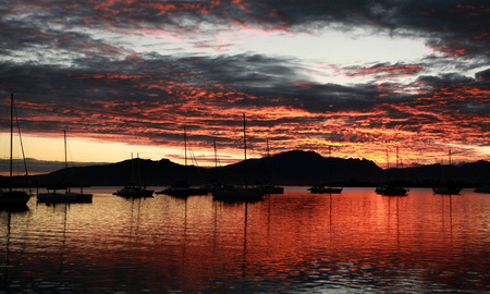 Silhouette Sail Boats at Sunrise at Port Denarau Fijiの写真素材