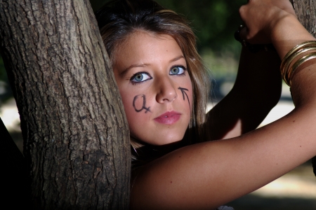 Painted face by a tree 5の写真素材