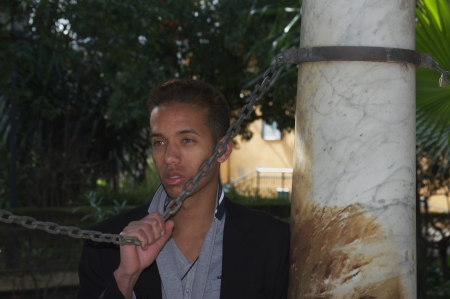 Black man by a marble column 59