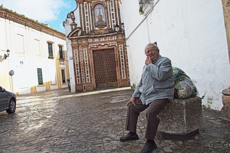 Spain, Seville, Carmona, 3rd April, 2013: Street Photography. Urban life. Sitting manのeditorial素材