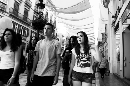 Malaga (Spain) 28th June 2013: Street photography. Young people walking and chattingのeditorial素材
