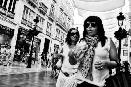 Malaga (Spain) 28th June 2013: Street photography. Young ladies walking and chattingのeditorial素材