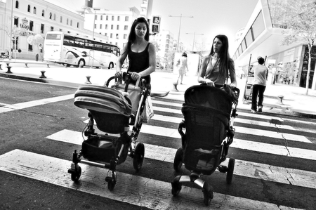 Huelva,  Spain  14th May, 2014  Street photography  Women with prams at the zebra crossingのeditorial素材