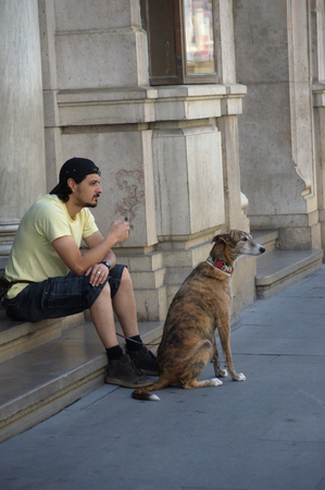 Sevilla, 24th May 2014 - Urban photography - Beggarman with dogのeditorial素材