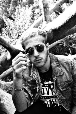 Male portrait by a dead,fallen tree trunk 18 の写真素材