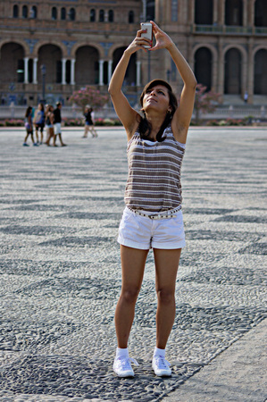 Seville, Spain, 18th August, 2014 - Urban life XLI - Young lady making a photoのeditorial素材