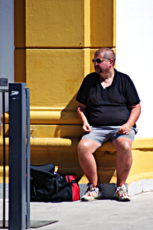 Seville, Spain, 18th August, 2014 - Urban life X - Man sitting in the sunのeditorial素材