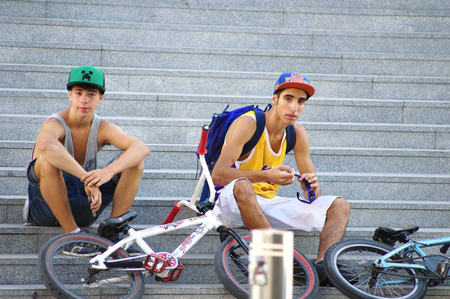 Seville  Spain 26th August 2014 - Urban life - Cyclists having a rest at the stairs XXのeditorial素材