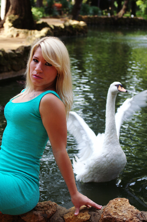 Young lady by the swans の写真素材