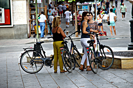 Sevilla - Spain - 19 July 2015 Urban life - Young ladies  with bicyclesのeditorial素材