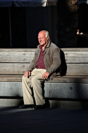 Sevilla, Spain, 11th September 2015 - Urban life -Old man sitting in the sunのeditorial素材
