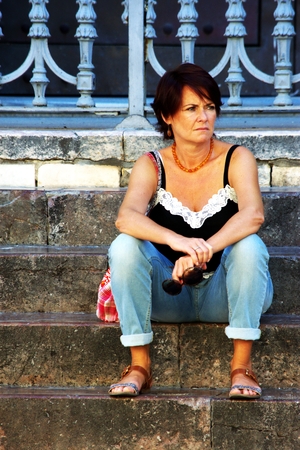 Seville - Spain - 5 August 2016- Urban life: Young lady sitting on some stepsのeditorial素材