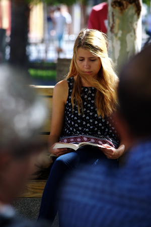 Seville, Spain, 27th September, 2016 - Urban life  - Young lady reading outdoorsのeditorial素材
