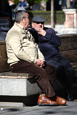Seville, 8th February 2017 - Urban life.  Men sitting in the streetのeditorial素材