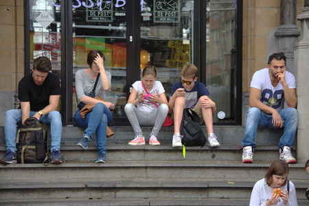 Ghent, Belgium 16-7-2017 - Urban life - People sitting on some stepsのeditorial素材