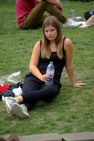 Brughes (Belgium) 12-7-2017  Urban life -  a girl sitting on the grassのeditorial素材