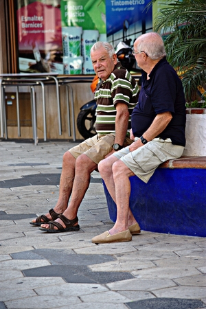 Almunecar (Granada) 11th August 2017 - Urban life - Seniors sitting in the streetのeditorial素材