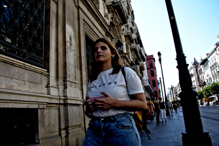 Seville, Spain, 4th October 2017 - Urban life - Young lady walking in the streetのeditorial素材