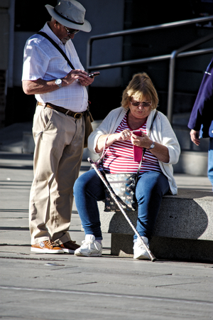 Seville, Spain, 14th November 2017 - Urban life. Old couple sitting outdoorsのeditorial素材