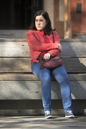 Seville, Spain, 24th January 2018 - Urban life - Young lady sitting out doorsのeditorial素材