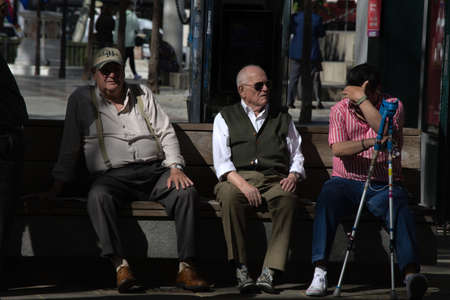 Seville 12th March 2020 SEniors relaxing and sitting on a publecc seat in Seville (Spain)のeditorial素材