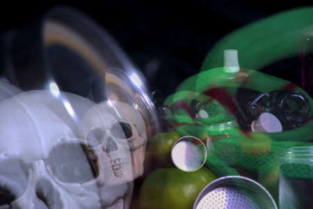 This is a still life with some bottles, some drills, and two apples