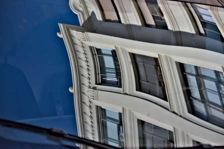 This is an urban photo. A building is reflected on a car glass. In Seville.の写真素材
