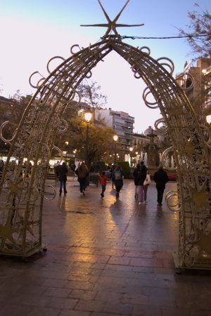 People in the streets of Granada in the evening when Christman lights are switched on for the first timeの写真素材