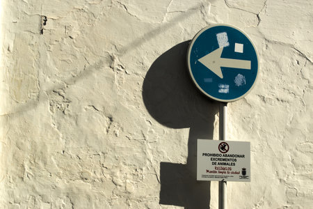 This is a traffic sign of mandatory address in an ordinary street in Carmona (Seville)の写真素材