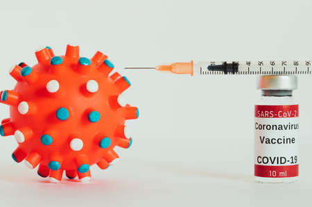 Covid-19 vaccine - coronavirus vaccination bottles. Ten injection vials with red cap on white background. Selective focus on the first vial. Immunization treatment. Bottles of ten milliliters.の写真素材