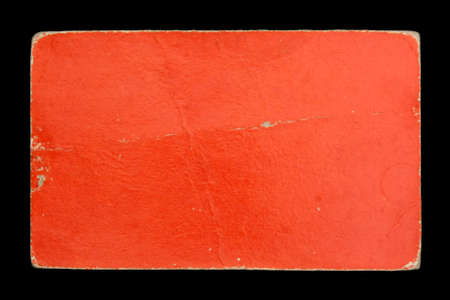 Old red cardboard label on black backgroundの写真素材