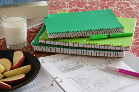 School notebooks and books with apple and milk snack