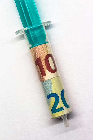 Aerial close-up of a Syringe with Euro Banknotesの写真素材