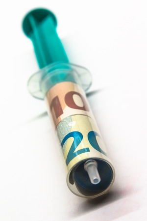 Close-up of a Syringe with Euro Banknotesの写真素材