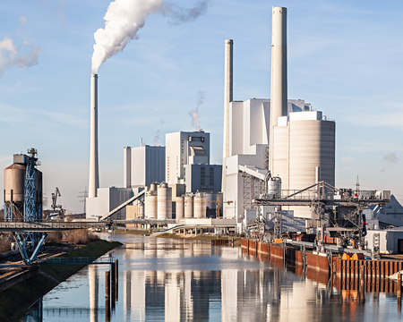 Coal Fired Power Plant with Smokestacks under Blue Skyの写真素材