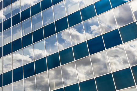 Outside View of Modern Office Building Reflecting the Skyの写真素材