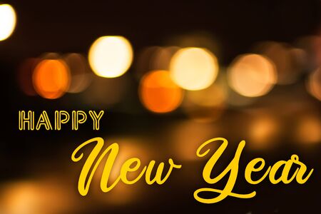 The Words Happy New Year with Blurred Lights in the Backgroundの写真素材